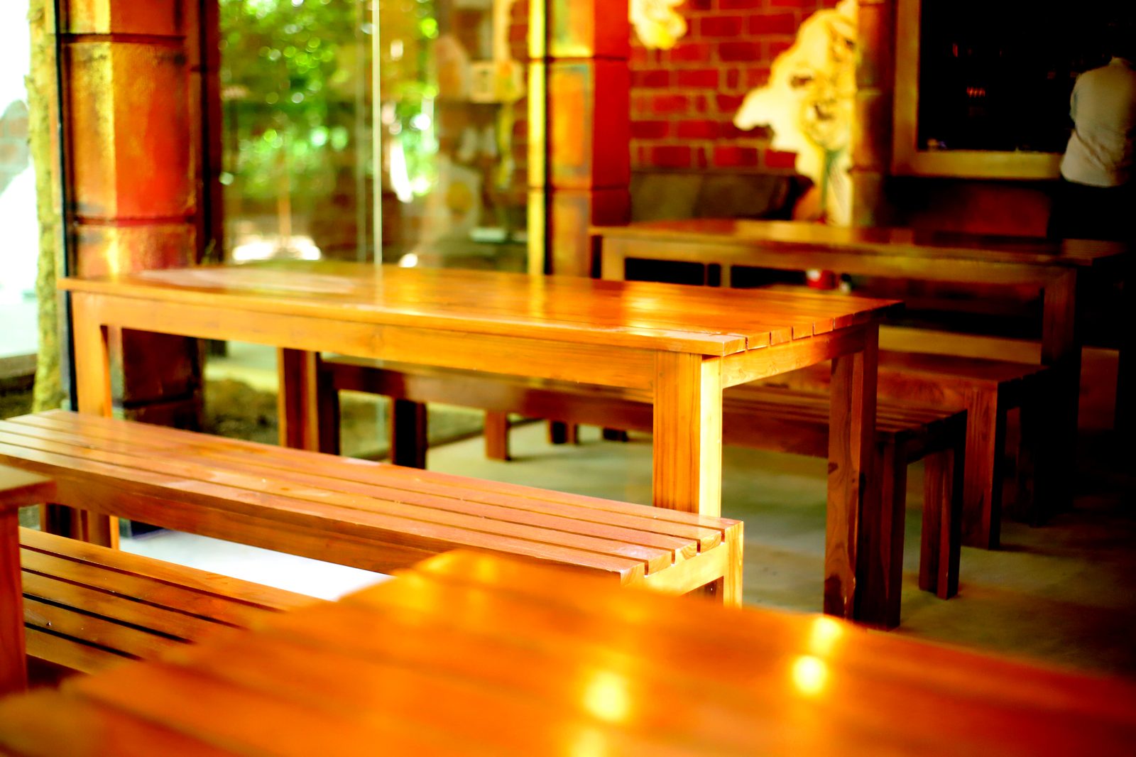 Open-air dining with hand-painted mural and brick walls